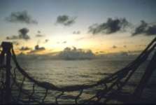 Fishing net over the water at sunset